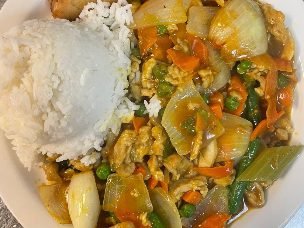 Chicken curry with onions, carrots, steamed rice and an egg roll at Shanghai Town