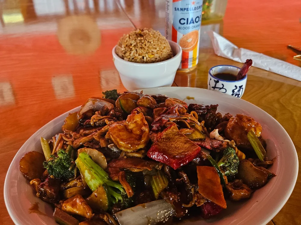 Assorted pan-fried noodles on a dining room table at Shanghai Town